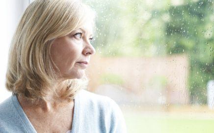 mature lady looking out of window